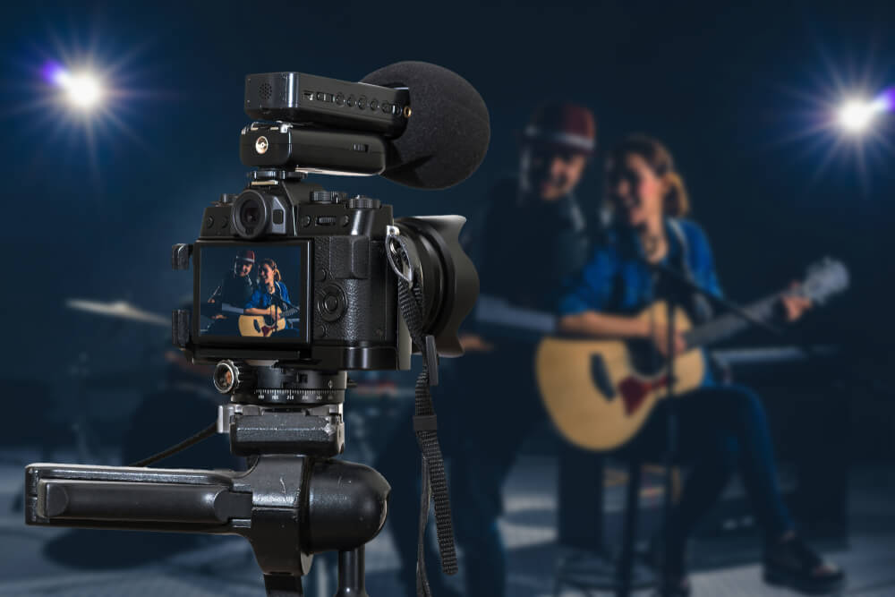 Professional Digital Mirrorless Camera With Microphone Recording Video Blog of Musician Duo Band Singing a Song and Playing Music Instrument